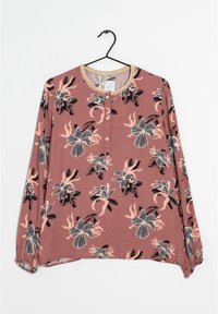 Langärmlige Bluse in Mauve mit Blumenmuster. Verfügt über einen runden Ausschnitt, Knopfverschluss und elastische Ärmelbündchen. Weicher Stoff mit leichtem Griff.