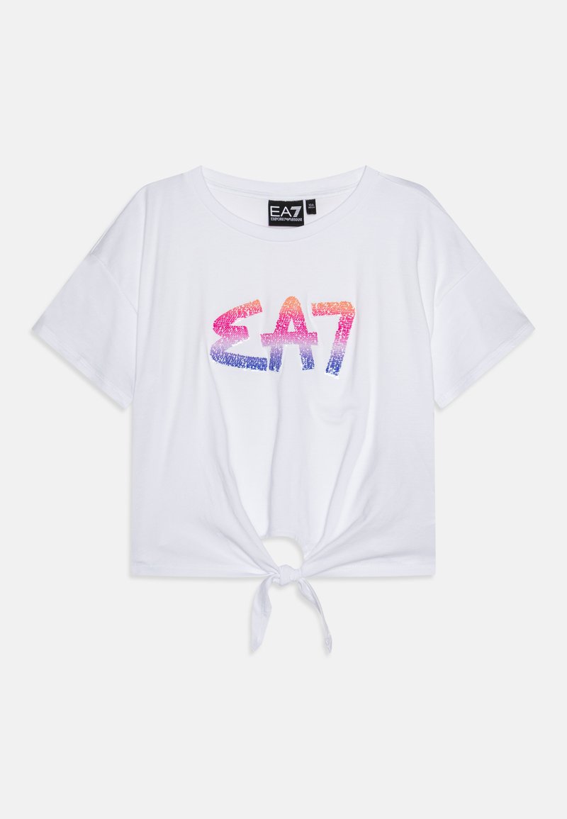 White cropped T-shirt in soft cotton with a round neckline, short sleeves, and a tie detail at the hem. Features a gradient EA7 logo design.