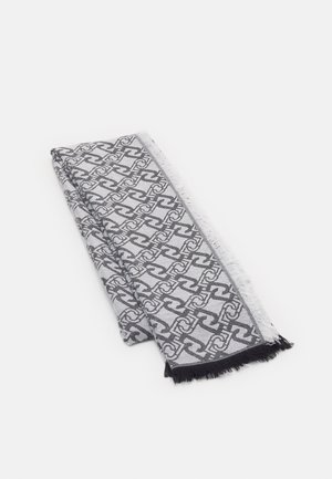 Écharpe noire et blanche pliée avec un motif géométrique de maillons de chaîne et des bords frangés sur un fond clair.