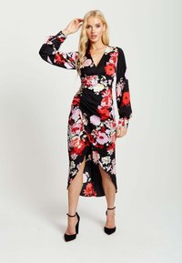 Black floral dress with long sleeves, featuring red and pink flowers, a v-neckline, a gathered waist, and front slits above the knee.