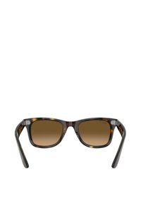 Occhiali da sole con lente color marrone e montatura effetto tartaruga. Design quadrato, aste sottili e dettagli in metallo argentato vicino alle cerniere.