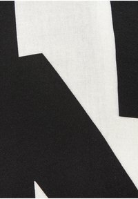 Black and white fabric featuring a bold, geometric pattern. The texture is smooth with a slight sheen. High-contrast design is prominent.
