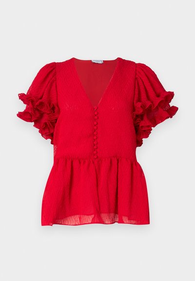 Red textured blouse featuring a deep V-neck, button detailing down the front, and ruffled short sleeves. Peplum style hem.