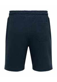 Short en éponge bleu marine avec taille élastique et une seule poche arrière, présenté de dos sur fond blanc.