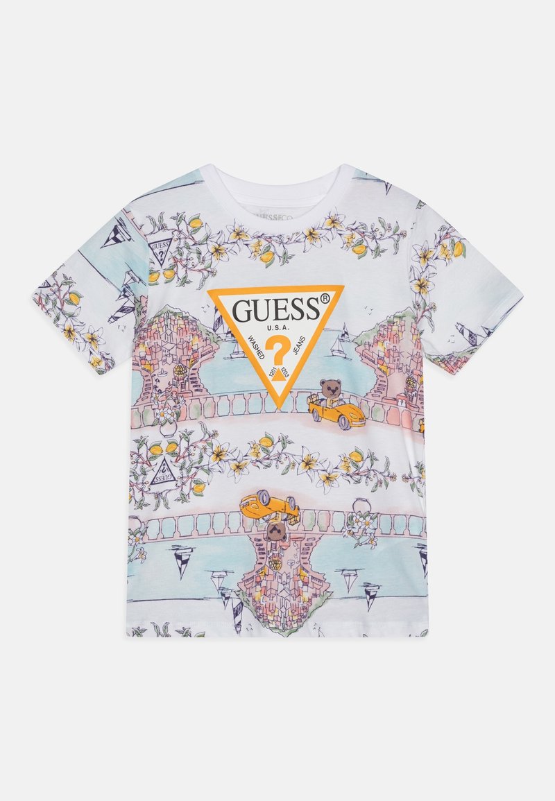 T-shirt blanc à manches courtes avec motifs floraux et citron, illustration d’une ville côtière, ours en peluche dans des voitures, et un grand logo orange Guess.