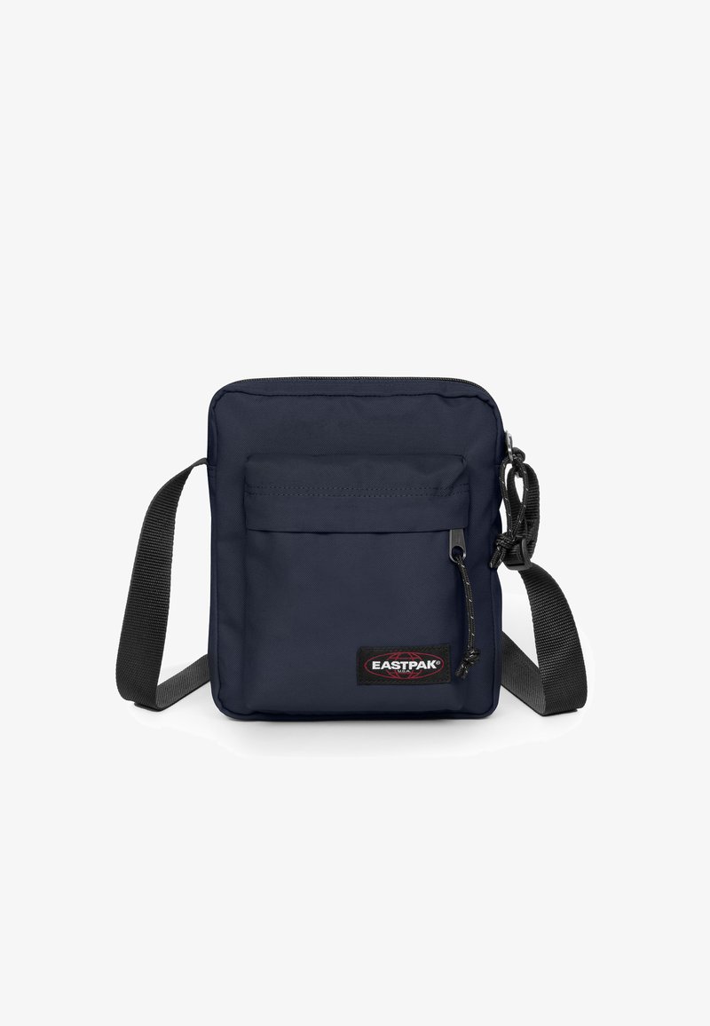 Granatowa torba na ramię wykonana z trwałego materiału, z przednią kieszenią na zamek, regulowanym paskiem oraz naszywką z logo Eastpak z przodu.