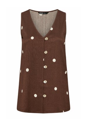 Ærmeløs brun bluse med knapper foran, hvide polka prikker og V-formet krave.