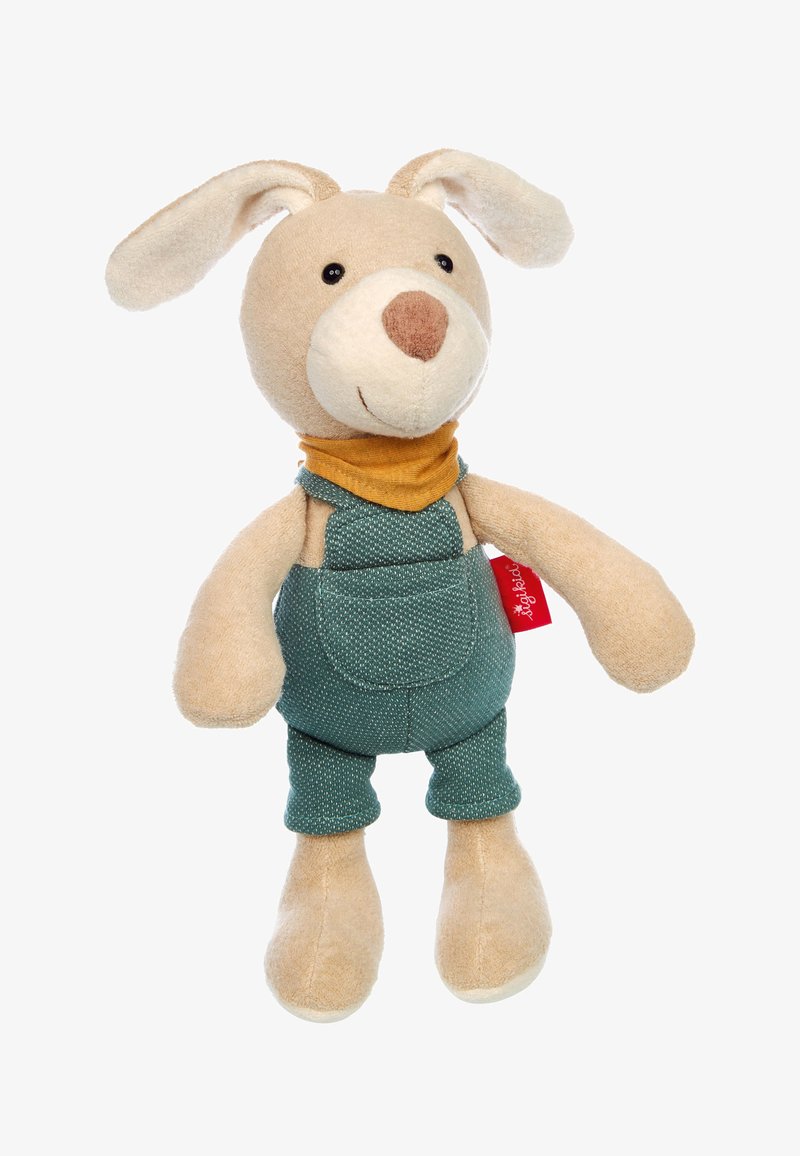 Peluche di cane con pelo color beige, occhi neri e naso marrone. Indossa una sciarpa gialla al collo e una salopette verde con una tasca. Texture morbida in tutto il corpo.