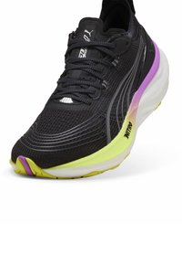 Black running shoe with a mesh upper, featuring gray accents, a white logo, and a multicolor midsole in yellow and purple.
