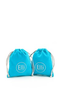 Turkise snorposer lavet af blødt stof, med et hvidt rundt logo og teksten "Elli by Julie & Grace". Glat tekstur, to poser vist.