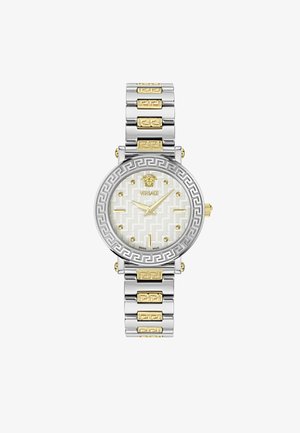 Nerezový hodinový stroj so strieborným a zlatým tónom, okrúhlym ciferníkom, bielym vzorovaným ciferníkom a akcentmi dizajnu gréckeho kľúča na náramku.