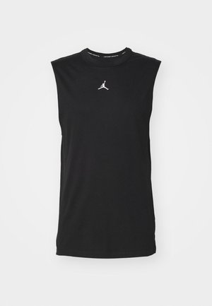 T-shirt de sport sans manches noir en coton, avec un col rond et un logo Jordan blanc sur la poitrine. Texture lisse, coupe régulière.