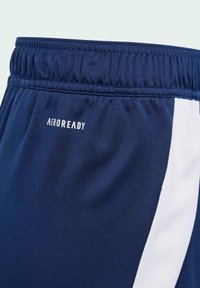 Navy athletic shorts with a textured fabric, featuring an elastic waistband and a white side panel. "AEROREADY" logo in white.