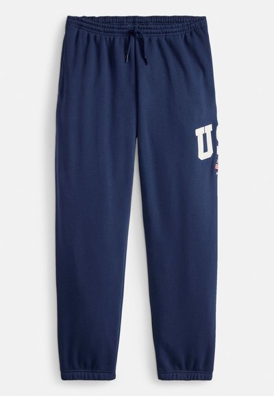 Marineblaue Sweatpants aus Baumwollmischung, mit elastischem Bund und Kordelzug, seitlichen Taschen und einem großen weißen "US"-Logo.