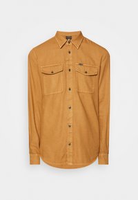 Koszula z długim rękawem zapinana na guziki, w ciepłym odcieniu brązu, wykonana z tkaniny przypominającej denim. Posiada dwie kieszenie na piersi oraz klasyczny kołnierzyk.