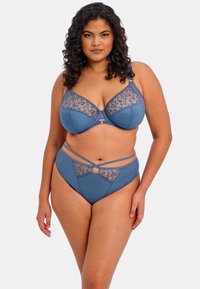 Blue lingerie set featuring a bra with lace detail and molded cups, and high-waisted briefs with sheer accents and crisscross straps.