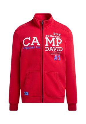 Red zip-up sweatshirt with high collar, featuring white and blue text. Two front pockets and ribbed cuffs for a fitted look.