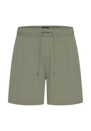 Heledad oliivrohelised ujumispüksid elastse vöökoha, paelaga sulgemise ja siledast, pehmest materjalist. Lihtne disain ilma mustriteta.