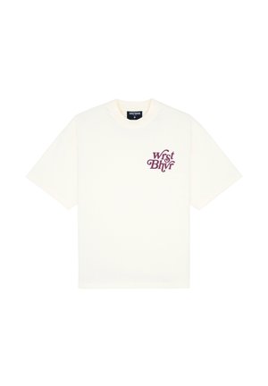 T-shirt oversize color crema in cotone con maniche corte; presenta il logo testuale viola "WrstBhvr" nella zona sinistra del petto.