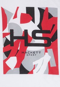 White cotton T-shirt featuring a graphic design with red, black, and gray geometric shapes; text reads "HACKETT SPORT" prominently.