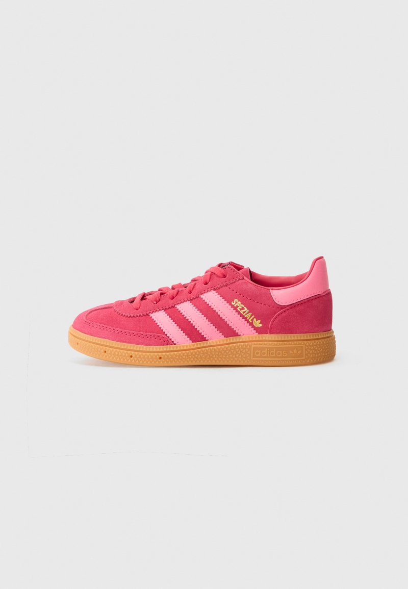 Rosa Wildledersneaker mit drei kontrastierenden hellrosa Streifen, goldenen Logo-Akzenten und einer Gummilaufsohle. Low-Top-Design mit abgerundetem Zehenbereich.