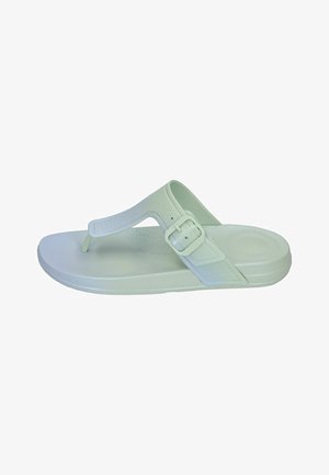 Light green flip-flop sandal with textured strap, adjustable buckle, and a flat sole. Smooth material with a minimalistic design.