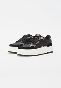 Black platform sneakers with a textured snakeskin pattern in gold and black. Features a suede toe cap and black laces. Rubber sole.