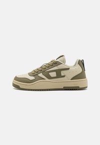Beige and olive green sneakers with a textured rubber sole, contrasting panels, and thick laces. Features a logo detail on the side.