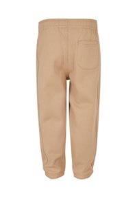 Beige Sweatpants für Kleinkinder mit elastischem Bund, elastischen Bündchen und einer einzigen Gesäßtasche auf der rechten Seite.