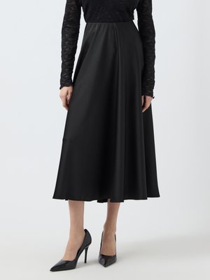 Gonna nera di lunghezza midi in un tessuto liscio e lucido con un design plissettato e una cintura in vita. Abbinata a scarpe con tacco a punta nere.