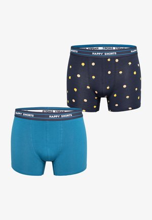 Two pairs of boxer shorts. One is solid teal; the other is navy with yellow fruit and burger patterns. Both feature a branded elastic waistband.