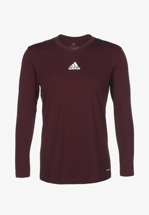 Maroon long-sleeve shirt with a v-neck design. Features the Adidas logo in white on the upper left chest. Smooth fabric texture.