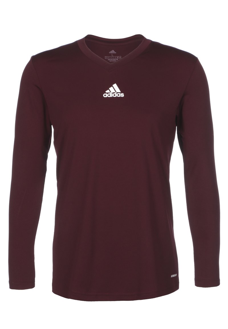 Bordeaux langærmet skjorte med V-hals design. Har Adidas-logoen i hvid på den øverste venstre bryst. Glat stoftekstur.