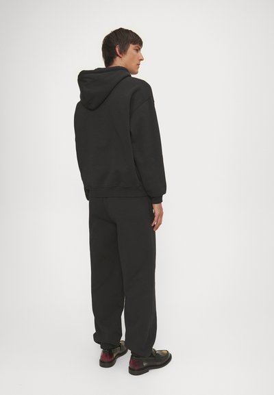Han Kjøbenhavn DAILY UNISEX - Tracksuit bottoms - black