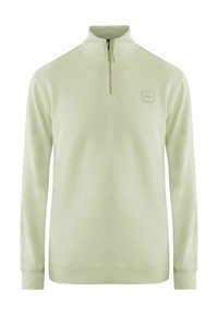 Suéter verde claro hecho de una tela suave, con un cuello de media cremallera, puños acanalados y una pequeña etiqueta con el logo en el pecho.