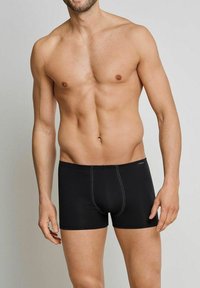 Black boxer briefs with a snug fit, made from soft, stretch fabric. Features contrast stitching and a branded waistband for comfort.