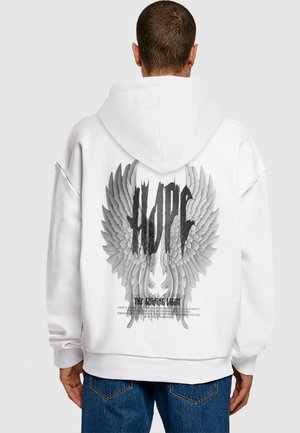 White hoodie featuring a large gray wing graphic with the word "HOPE" in bold black font above and "THE Guiding Light" text below.