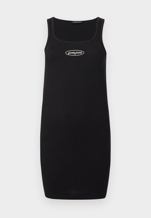 Fekete bordázott pántos ruha négyzet alakú dekoltárral, középen fehér "guess jeans" logóval a mellkasán. Egyszerű és testhezálló kialakítás.