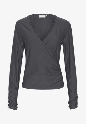 Garais, ilgs piedurkņu top ar V veida izgriezumu, izgatavots no mīksta auduma. Iespējo pamanījušos sānu izšuvumus un pieguļošas piedurknes ar ručām pie aprocēm.