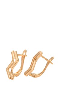 Et par polerede guldringe med en vinkelret, zigzag-design og hængslet låsesystem på en hvid baggrund.