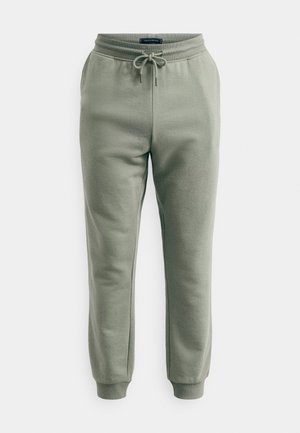 Lichtgroene sweatpants met een verstelbare tailleband, ribbelzoom bij de enkels en een zachte stoftextuur. Geen extra patronen of versieringen.