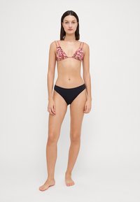 Floral-patterned bikini top with adjustable straps and a black low-rise bikini bottom. Material appears smooth with a soft texture.