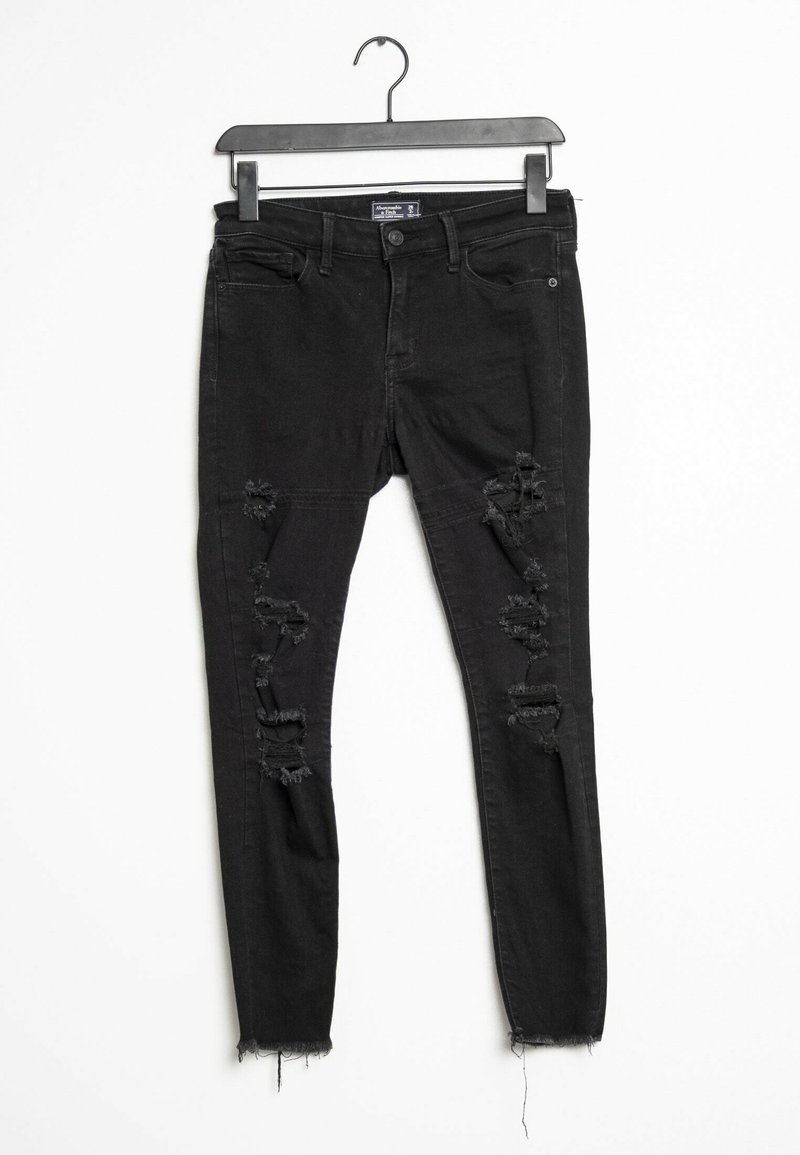 Černé džíny skinny s opotřebovaným vzhledem, trhanými detaily, a roztrženými lemami, klasický design s pěti kapsami. Vyrobeny z denimové tkaniny, s knoflíkovým zapínáním.