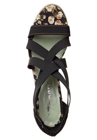 Sandale noire avec des brides élastiques croisées et une semelle intérieure à motif floral, vue de dessus.