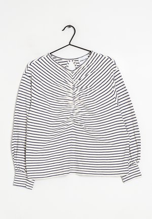Striped long-sleeve shirt with navy and white colors, featuring a gathered design at the front and a keyhole opening at the back.