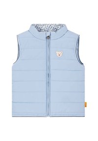 Světle modrá vyp puffa vesta s předním zipem, vertikálním švem a nášivkou medvídka. Podšitá látkou s květinovým vzorem, lehký design.