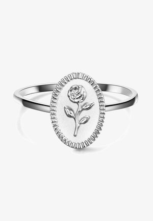 Silver ring featuring an oval-shaped center with a raised rose design, surrounded by a textured edge. Smooth band, polished finish.