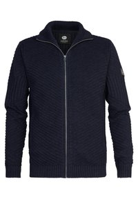 Marinblå zip-up cardigan med ett texturerat zigzag-mönster och ribbade manschetter. Har en hög krage och en liten logotyp patch på ärmen.