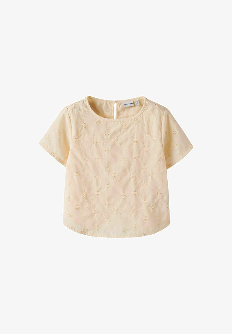 Top a maniche corte di colore giallo chiaro con ricami floreali, scollatura rotonda e dettaglio con bottone sul retro. Tessuto morbido con una superficie liscia.