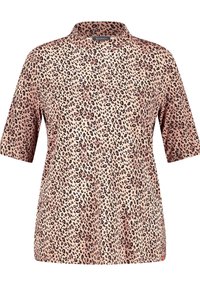 Haut à manches courtes en imprimé léopard de couleur rose pâle. Tissu doux avec une texture lisse, doté d'un col légèrement structuré et d'une coupe décontractée.